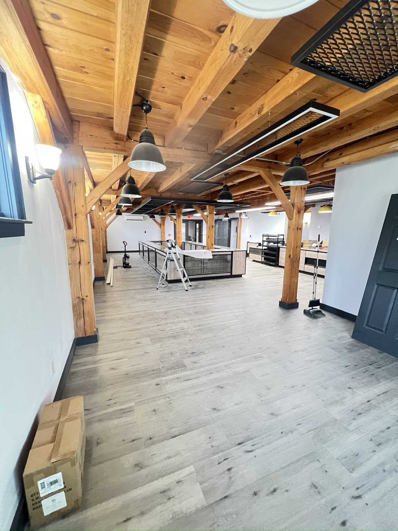 The sales floor taking shape. Timber posts, wood ceiling, and a lot still to do.